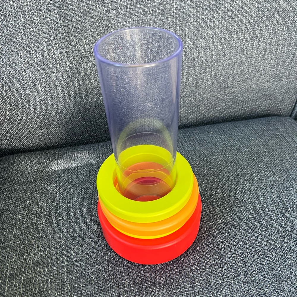 Lovevery toy tube with wooden rings
